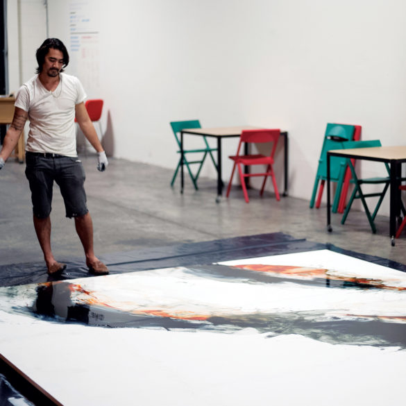 Matthew James ’00 at work on a large-scale painting created for a show in Kaka‘ako in 2015. It was recently installed at Waialua High School.